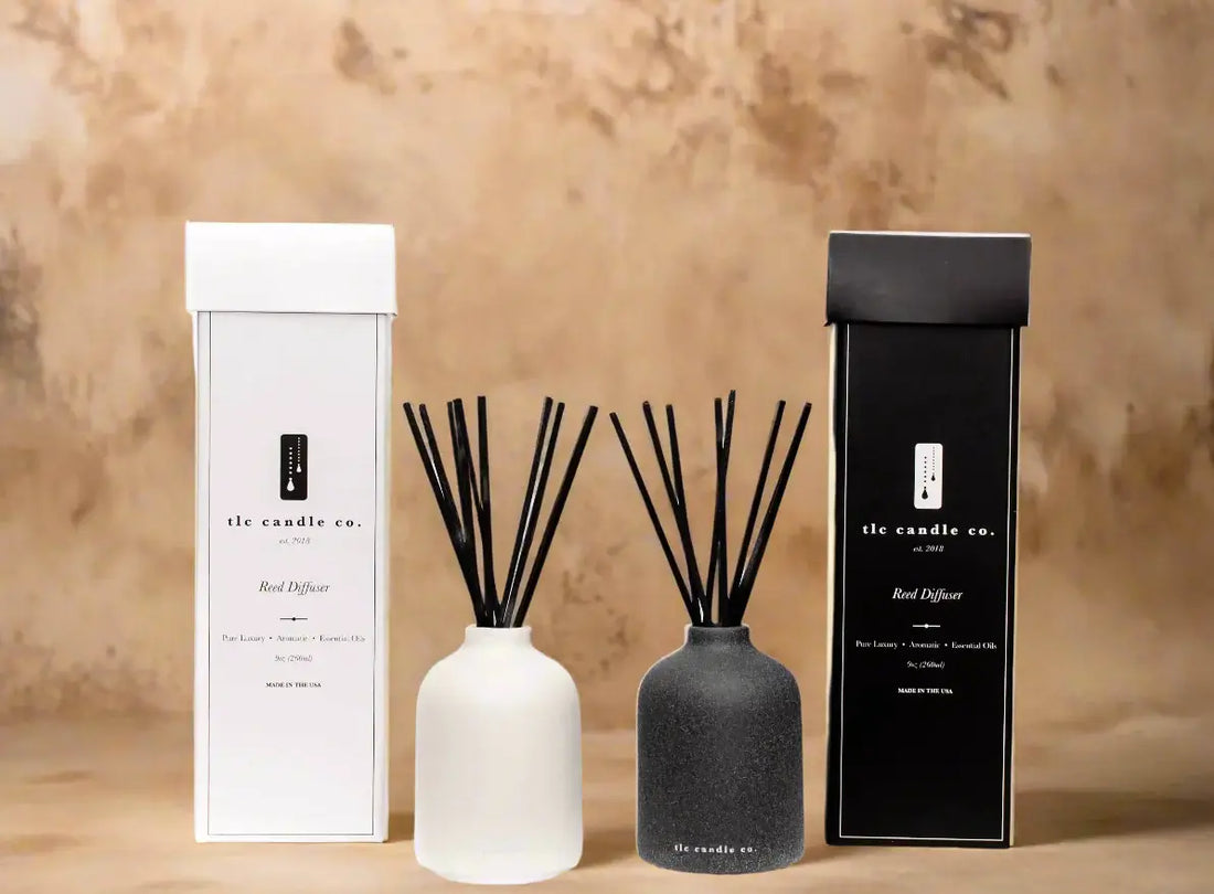 Elegant reed diffusers in white and black packaging, showcasing natural citrus scents for a refreshing ambiance.